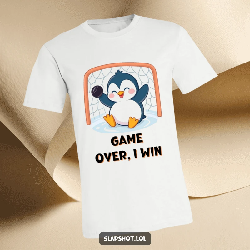 Funny penguin t-shirt with a giggling character scoring a goal with a puck, perfect for hockey enthusiasts.