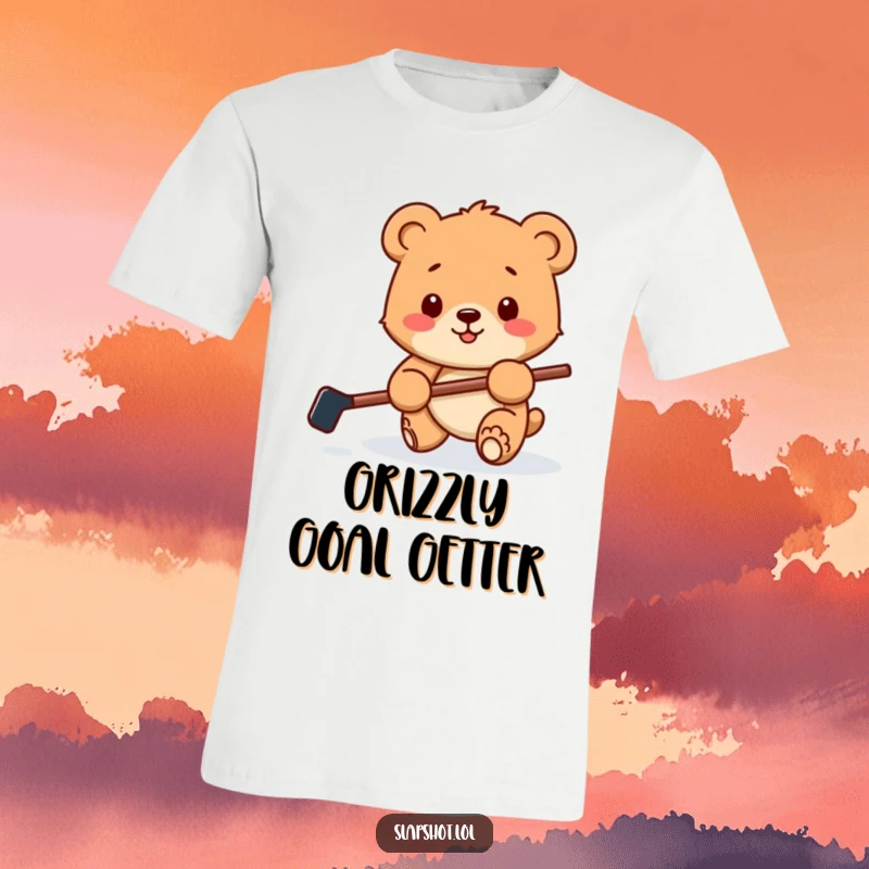 Funny t-shirt with a happy bear cub holding a tiny hockey stick, playfully batting a puck, capturing a moment of adorable action.