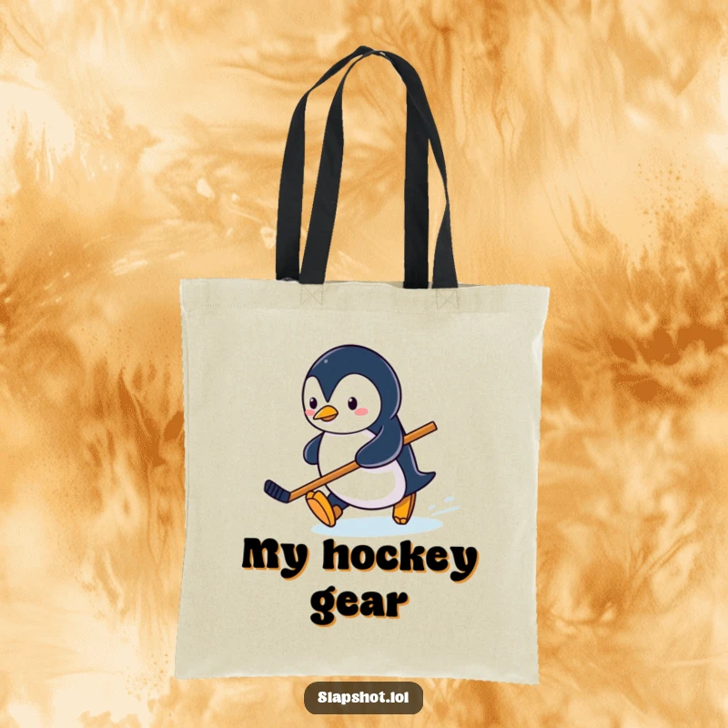 Funny penguin character sliding on an ice rink with a miniature hockey stick on a durable tote bag.